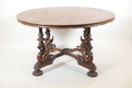 A late C19th/early C20th walnut coffee table, with carved and shaped edge top, raised on four
