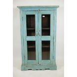 An Indian painted hardwood two door display cabinet, 32" x 14" x 54"