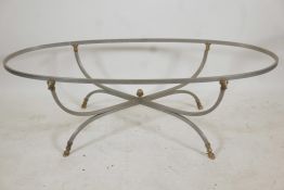 A brushed steel occasional table with brass ram's mask mounts and hoof feet, 52" x 22½", 17" high