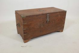 An Indian teak box with brass mounts, fitted with three trays, later supports, 12" x 25" x 13"