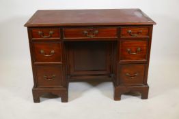 A C19th mahogany seven drawer kneehole desk, with inset blind tooled leather top and brass swan neck