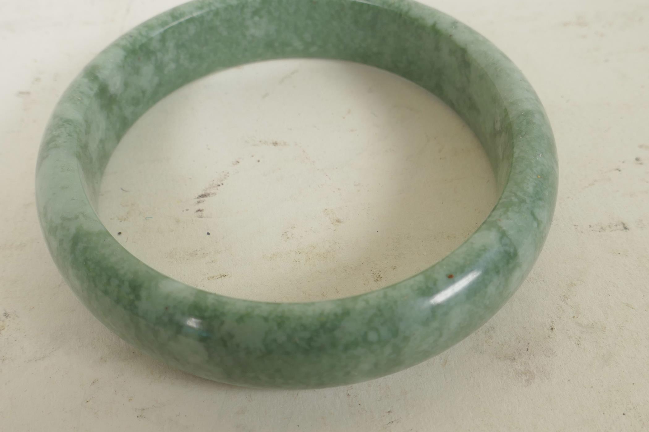 A Chinese green hardstone bangle, 3" diameter - Image 2 of 2