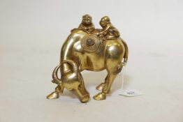 A gilt bronze figure of two boys riding a water buffalo, 6" high