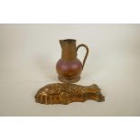 An Arts and Crafts copper jug, together with a coppered metal jelly mould in the form of a fish,
