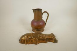 An Arts and Crafts copper jug, together with a coppered metal jelly mould in the form of a fish,