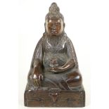 A Chinese bronze figure of a bearded Immortal seated in meditation, 12" high