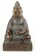 A Chinese bronze figure of a bearded Immortal seated in meditation, 12" high