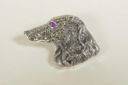 A sterling silver brooch in the form of an Afghan set with marcasite, 1"