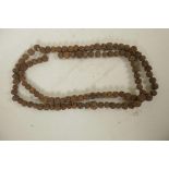 A string of nut kernel beads, 66" long