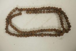 A string of nut kernel beads, 66" long