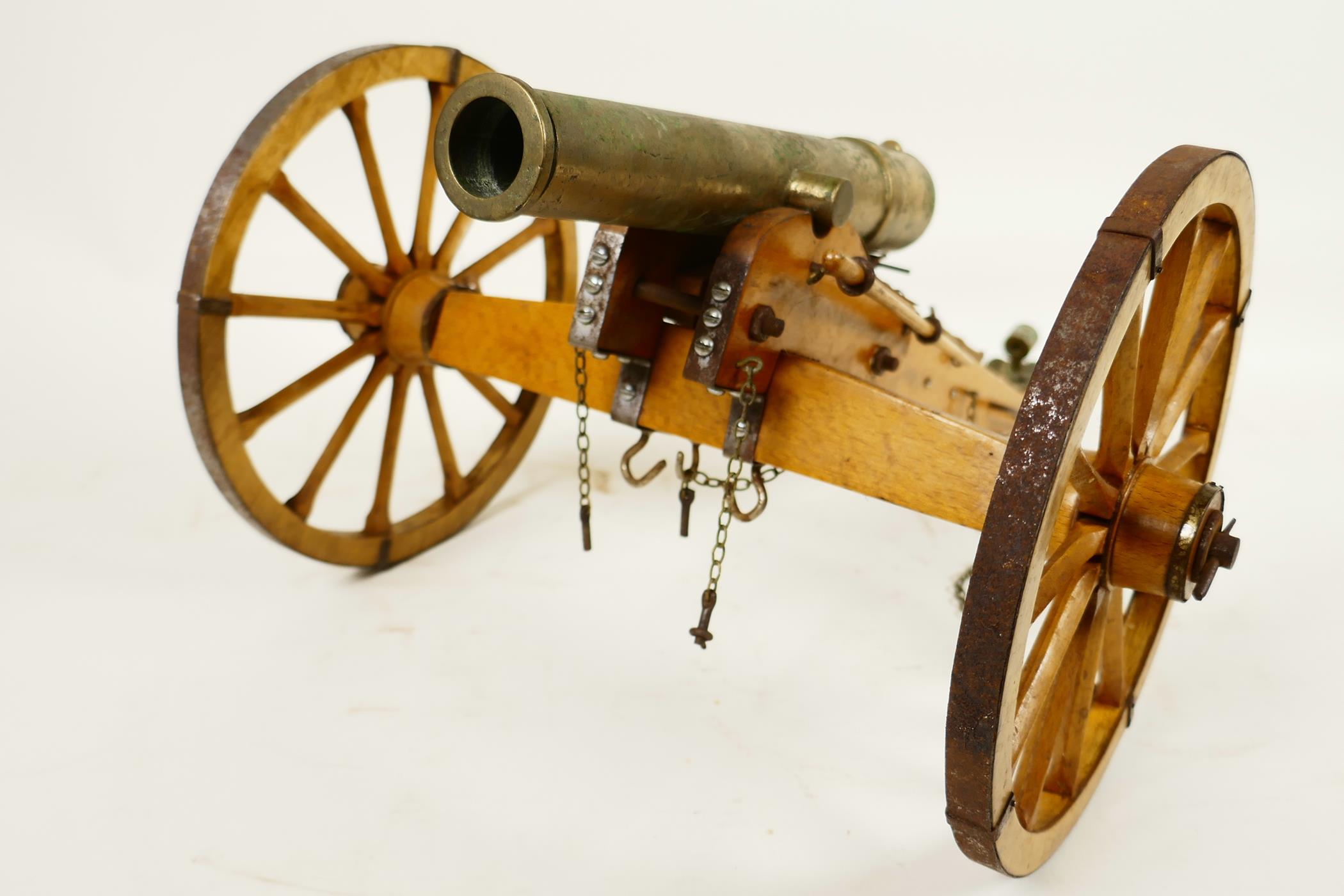 An antique ornamental table top bronze cannon, on a hand made wooden carriage with metal fittings, - Image 4 of 4