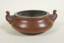 A Chinese bronze censer with two elephant mask handles, impressed mark to base, 5½" diameter