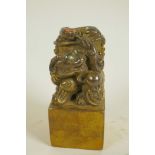 A Chinese gilt bronze seal, the top formed as mythical beasts set with coloured stones, on square 5"