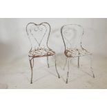 A near pair of vintage, painted wrought iron garden chairs