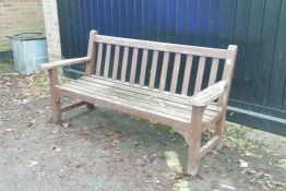 A weathered teak garden bench, 64" wide