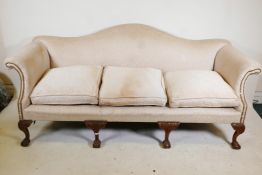 A Chippendale style humpback settee, with scroll arms, raised on carved cabriole supports with