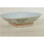 A Chinese lobe shaped porcelain dish painted with flowers and berries in bright enamels, 10" wide