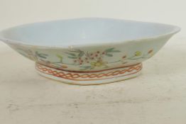 A Chinese lobe shaped porcelain dish painted with flowers and berries in bright enamels, 10" wide