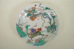 A Chinese famille verte porcelain charger decorated with a kylin and phoenix, 6 character mark to