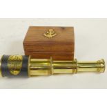 A small brass three draw telescope in a hardwood box, 7" long extended