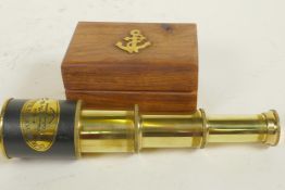 A small brass three draw telescope in a hardwood box, 7" long extended