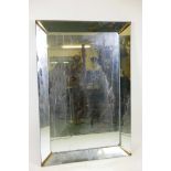 A mid century sectional wall mirror with brass corner mounts, 51" x 35"