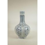 A Chinese Ming style blue and white porcelain bottle vase of ribbed form, decorated with flowers,