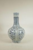 A Chinese Ming style blue and white porcelain bottle vase of ribbed form, decorated with flowers,