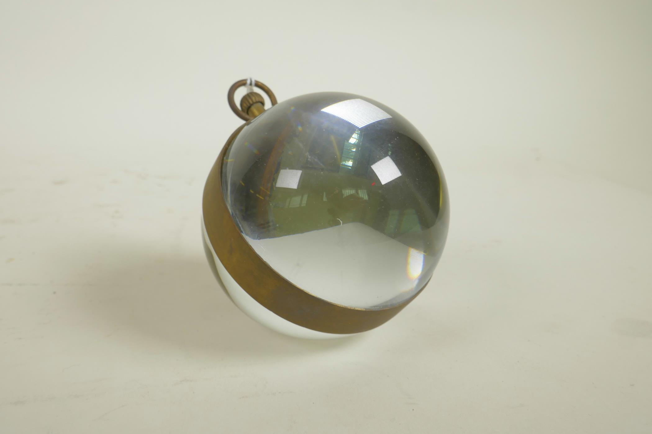 A glass ball desk, brass bound, clock, 3" diameter