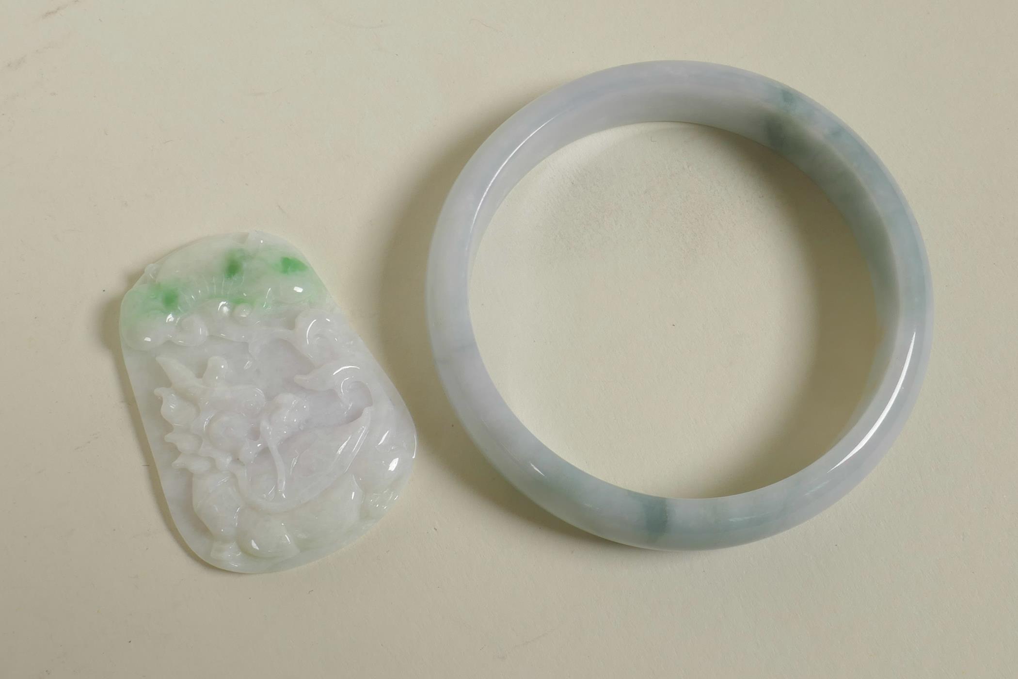 A Chinese marbled green jade bangle, and a carved jade pendant with dragon tortoise decoration,