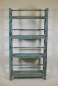 An Indian hardwood four tier open shelf with distressed paintwork, A/F minor break, 36" x 12" x 70"
