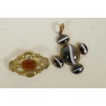 A gilt metal and banded agate set pendant, and a gilt metal brooch set with an orange gemstone,