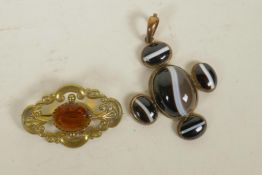 A gilt metal and banded agate set pendant, and a gilt metal brooch set with an orange gemstone,