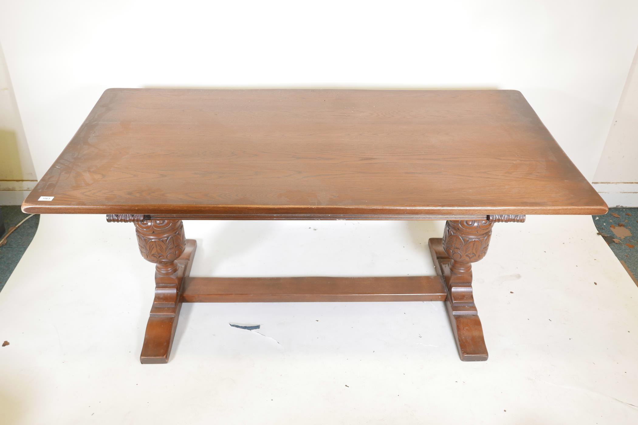 A plank top oak refectory table with bulbous carved end supports, 66" x 33½", 30" high - Image 2 of 3