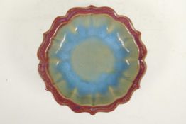 A Chinese Jun ware pottery shallow dish of lobed form on tripod supports, 7½" diameter