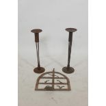 A pair of wrought metal pricket candlesticks and a riveted metal wall bracket, 17½" high