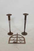 A pair of wrought metal pricket candlesticks and a riveted metal wall bracket, 17½" high