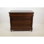 A C19th French mahogany commode with three moulded front drawers flanked by fluted columns, raised