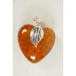 A silver mounted faux amber heart shaped pendant, 1½" long