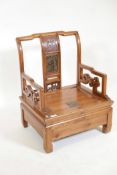 A Chinese fruitwood low commode chair with carved and painted decoration to the back splat, 21" x