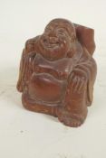 A Japanese okimono carved as a jolly man with large sack, 2¼" high