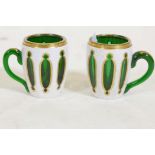 A pair of Bohemian overlaid and gilt glass mugs, 3½" high