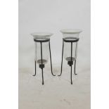 A near pair of glass and wrought iron hurricane lanterns on tripod stands, 17½" high, A/F