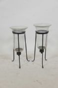 A near pair of glass and wrought iron hurricane lanterns on tripod stands, 17½" high, A/F