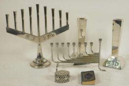 A Menorah, 9" high, another nine light candlestick, a pair of square section candlesticks, a small