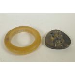 A Chinese faux horn bangle, and a horn pendant with carved kylin decoration, 3½" diameter