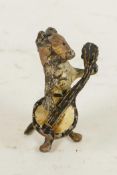 A miniature cold painted bronze figurine of a dog playing a banjo, 1¾" high