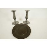 A pair of pewter Queen Anne style candlesticks, 6½" high, and an antique pewter plate, 7¾" diameter