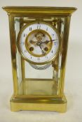 A Tiffany brass cased four glass mantel clock with exposed Brocot escapement and mercury pendulum,