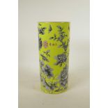 A Chinese yellow ground porcelain cylinder vase with black and white floral decoration, red